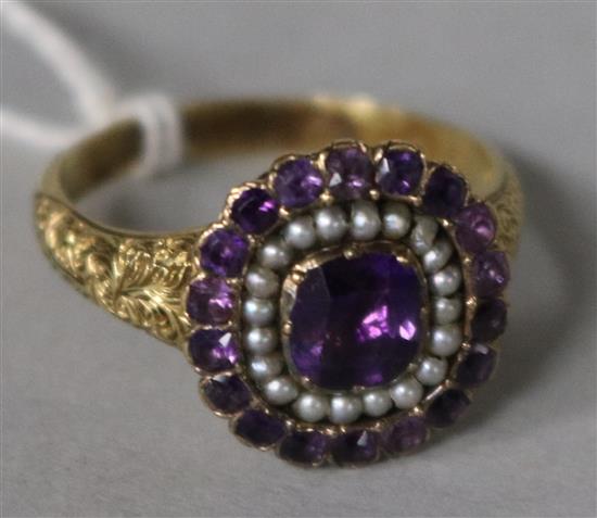 A Victorian 18ct gold, amethyst and seed pearl cluster dress ring, size O.